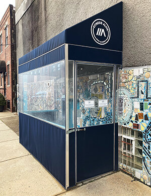 The blue awning entrance to Fitness Alive South Philly
