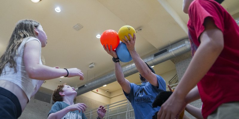 Campers tossing balls in the gym