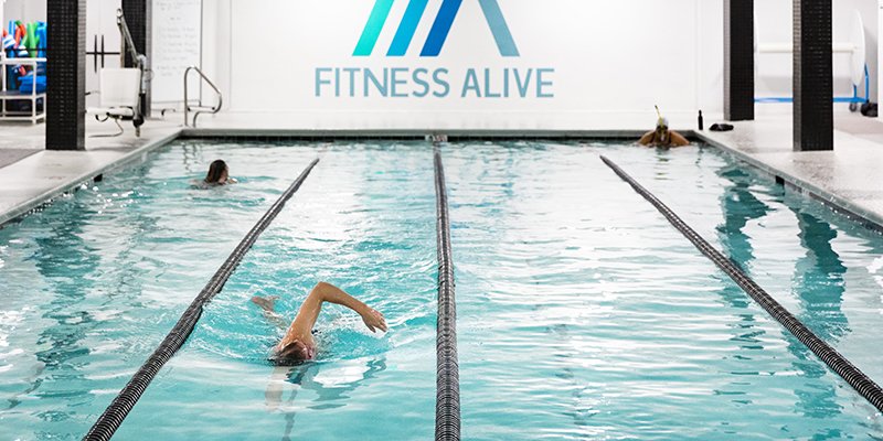 A swimmer doing freestyle in the lap lanes at the Fitness Alive pool